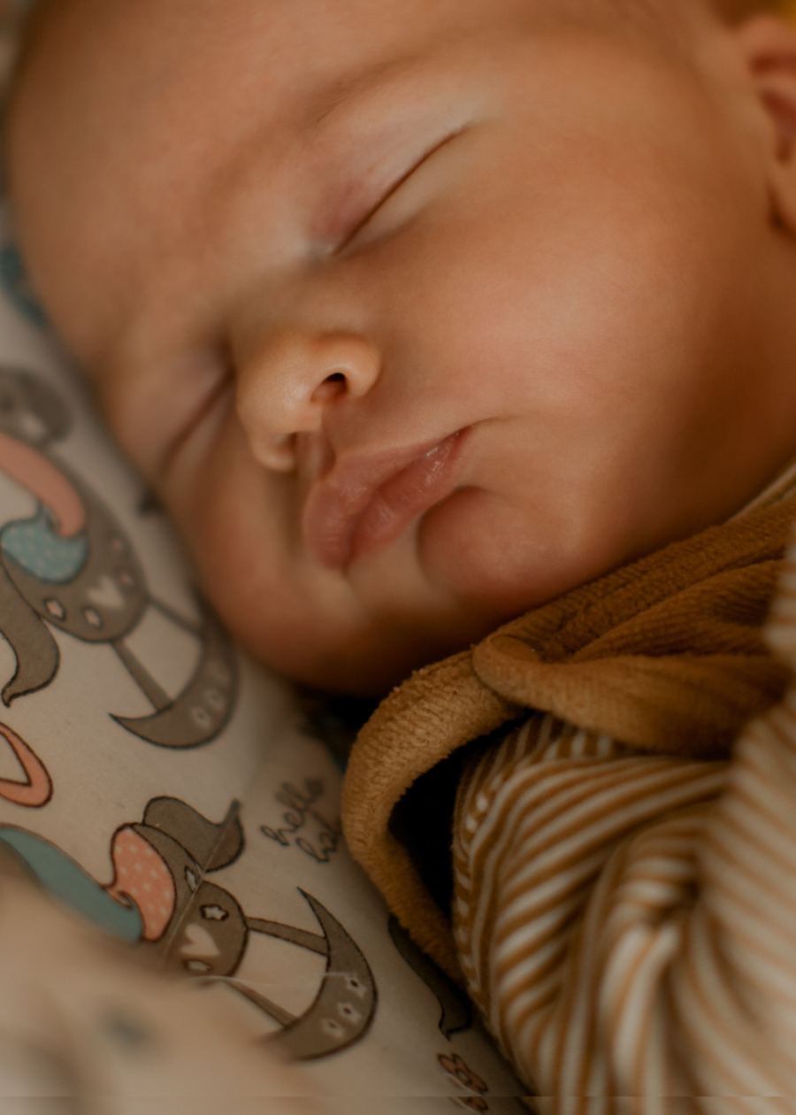 Baby auf Strickdecke in warmen Ockertönen