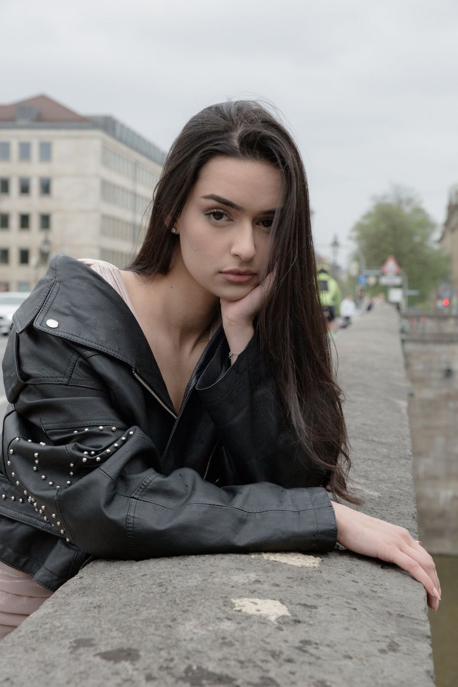 Fashion-Porträt in Weiß, Frau an einer Steinbrüstung