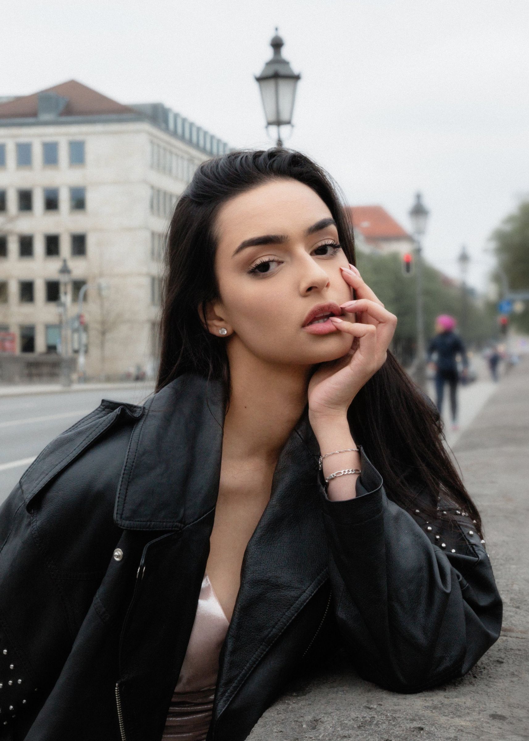 Fashion-Porträt in Weiß, Frau an einer Steinbrüstung